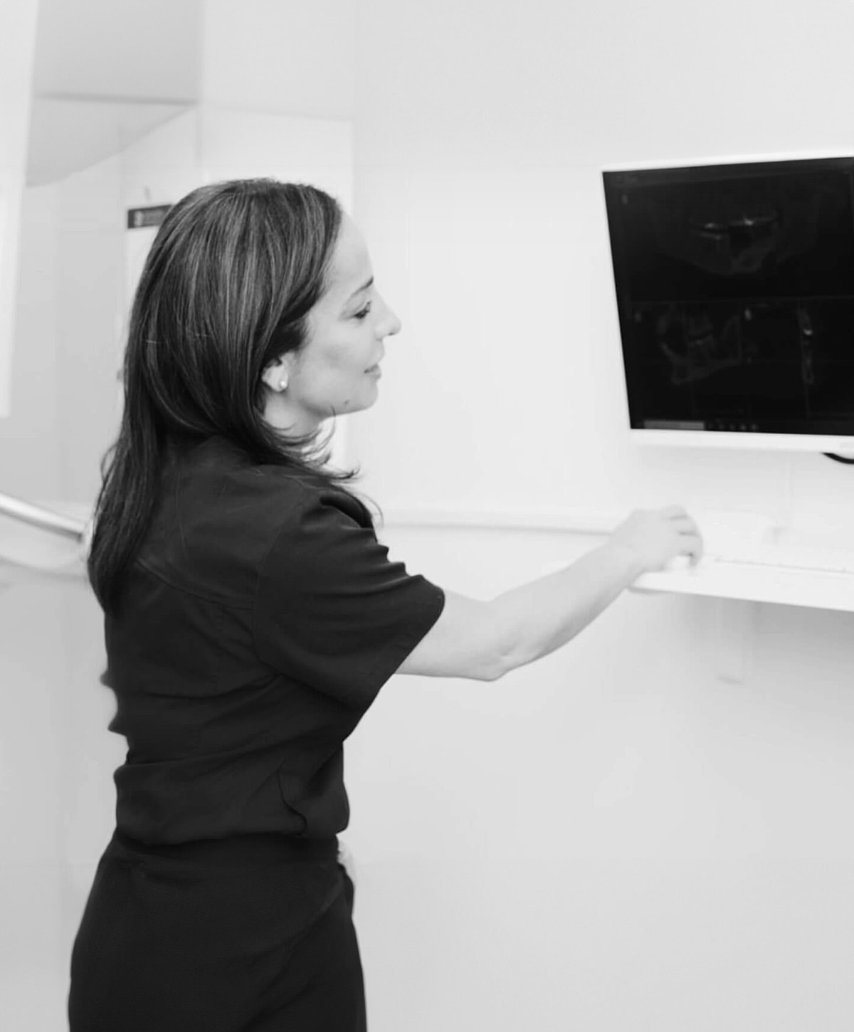 Healthcare professional interacting with medical equipment.